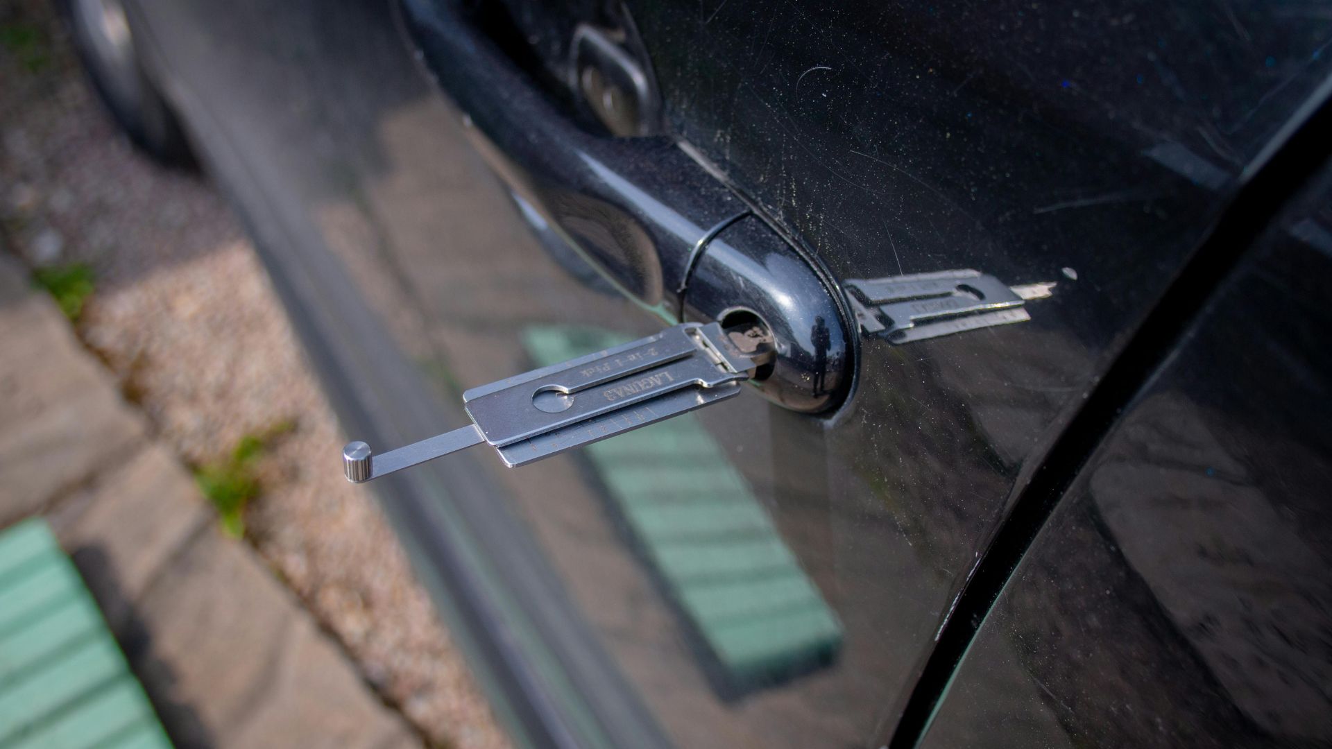 Car door lock with key inserted, showing detailed metallic mechanism